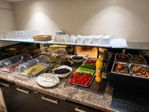 a buffet with many different types of food on a counter at Epidavros Hotel in Athens