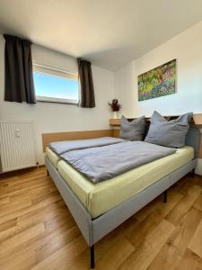 a bedroom with a large bed in a room at Panoramic - Wanderlust #329 mit Schwimmbad in Hohegeiß