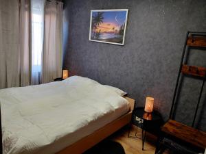 a bedroom with a bed and a picture on the wall at Sunny Days Cozy and Comfortable Apartment in Boutersem