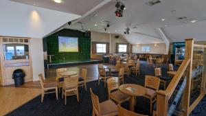 a restaurant with tables and chairs and a bar at Snowdon Summit 062 in Barmouth