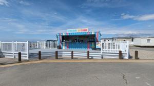 a food stand on a pier with a white fence at Snowdon Summit 062 in Barmouth