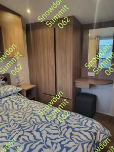 a bedroom with a bed and a desk and a mirror at Snowdon Summit 062 in Barmouth +14 photos