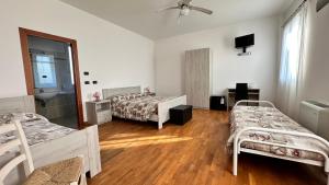 a room with two beds and a sink in it at Locanda dei Sapori in Marozzo