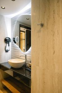 a bathroom with a sink and a mirror at Black Rocks Family Beach Resort in Agios Gordios