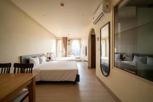 a hotel room with a bed and a couch at Weal Apartment in Danang