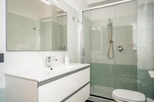 a bathroom with a shower and a sink and a toilet at Japo House - Like at your house in Pusiano +15 photos