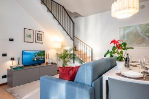 a living room with a blue couch and a tv at Japo House - Like at your house in Pusiano