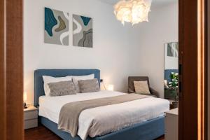 a bedroom with a bed with a blue headboard at Japo House - Like at your house in Pusiano