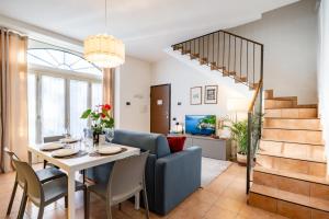 a dining room and living room with a table and chairs at Japo House - Like at your house in Pusiano