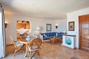 a living room with a blue couch and a table at Las Escaleras - Villa PEKA - 4S in Port d’Andratx