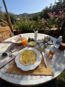 a table with a white plate of food on it at Bin Jbal Resort in Ouirgane