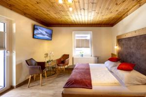a bedroom with a bed and a table with chairs at Haus am Lift in Kleinarl +58 photos