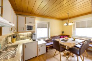 a kitchen with a table and a dining room at Haus am Lift in Kleinarl
