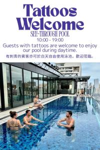 a group of people sitting in a swimming pool at Hotel Aqua Citta Naha in Naha