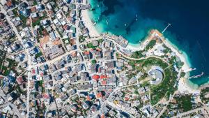 an satellite image of a city next to the ocean at Hotel Parid in Ksamil