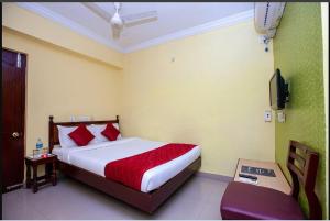 a bedroom with a bed and a television in it at JPResidency in Pondicherry