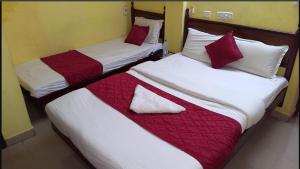 two beds sitting next to each other in a room at JPResidency in Pondicherry