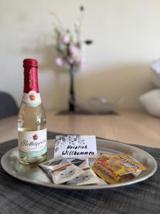 a bottle of alcohol and a plate of food at Panoramic - Wanderlust #329 mit Schwimmbad in Hohegeiß