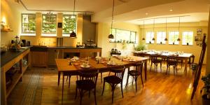 a kitchen and dining room with tables and chairs at De Melkfabriek in Eckelrade