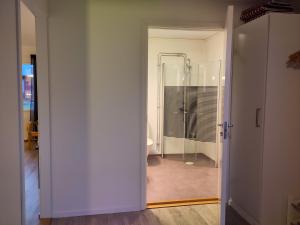 an open door to a bathroom with a shower at Tärnaby Sportstugor in Tärnaby +34 photos