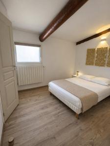 a bedroom with a large bed and a window at Mini Villa avec piscine privée in Porto-Vecchio +22 photos