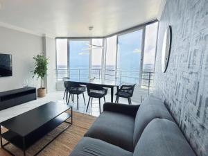a living room with a couch and a table at Sea Esta On Beach in Strand