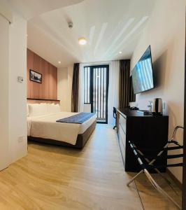 a hotel room with a bed and a television at Sri Gaya Hotel in Kota Kinabalu