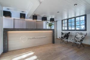 a meeting room with two chairs and a reception desk at Hotel Austria by Pierre & Vacances in Soldeu