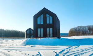 a small house in the snow with snow at Domki Lubikowo in Przytoczna 