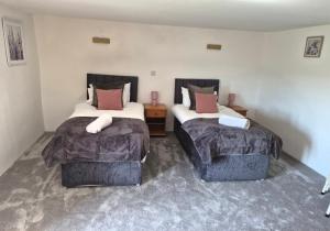 two beds in a room with two beds sidx sidx sidx sidx sidx at Dean Linhay in Lynton