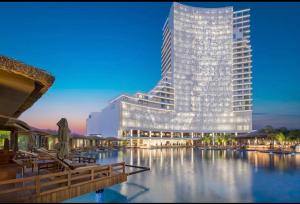 a rendering of a tall building with water in front at Grand Saphire Resort c blok in Aradhippou +4 photos