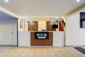 a hotel lobby with a hotel sign on a counter at Super Hotel O Ananthpur Formerly TR Residency in Anantapur