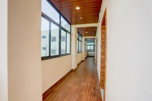 an open hallway with windows and a wooden ceiling at Super Hotel O Ananthpur Formerly TR Residency in Anantapur