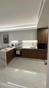 a large kitchen with a counter and a sink at Grand Saphire Resort c blok in Aradhippou