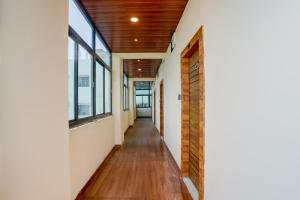 a hallway of a house with windows and a wooden ceiling at Super Hotel O Ananthpur Formerly TR Residency in Anantapur +27 photos