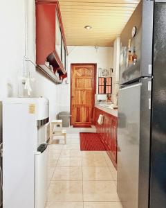 a kitchen with a stainless steel refrigerator and a door at Casa Clara La Union in Dalumpinas Oeste +7 photos