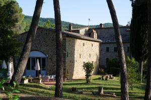 a building with a bunch of palm trees in front of it at Il Maggese in Cortona