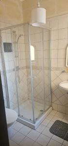 a shower with a glass door in a bathroom at Quiet, spacious 3 bedroom 2 bathroom apartment in Għajnsielem +15 photos