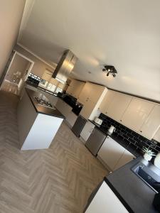 an aerial view of a kitchen with white cabinets at Waterside House in Kilbarchan +9 photos