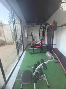 a room with a gym with weights and a treadmill at Itawis Resort - Balai Angel in Silang