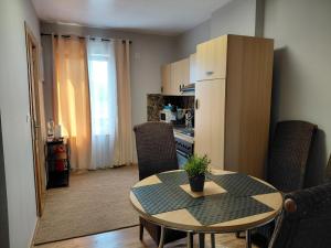 a kitchen and dining room with a table and chairs at Sunny Days Cozy and Comfortable Apartment in Boutersem