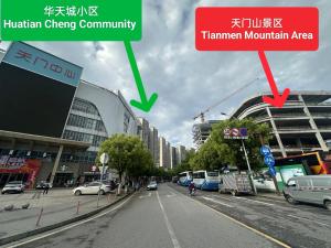 a city street with buildings and cars on the road at Sky Gate Guesthouse-English Speaking Hostess, Family friendly,2-minute walk to Entrance of Tianmen Mount ,Free pick up service,Book attraction tickets, Free Laundry,Private Tour in Zhangjiajie
