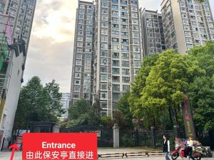 a tall building with a sign in front of it at Sky Gate Guesthouse-English Speaking Hostess, Family friendly,2-minute walk to Entrance of Tianmen Mount ,Free pick up service,Book attraction tickets, Free Laundry,Private Tour in Zhangjiajie