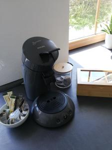 a food processor sitting on the floor next to a bowl at Himmelthal Apartment in Eschau