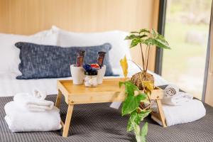 a room with a table with towels on a bed at Bushwalk Escape 1770 in Agnes Water