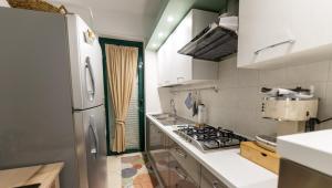 a kitchen with a refrigerator and a stove at Il Bergamotto in Bitritto