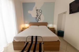 a bedroom with a bed and two chairs in it at Il Bergamotto in Bitritto