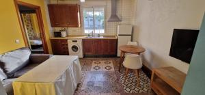 a kitchen with a couch and a table in a room at Ganado26 in Sanlúcar de Barrameda