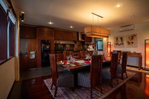 a kitchen and dining room with a table and chairs at Villa Ambiente by Nakula in Jimbaran