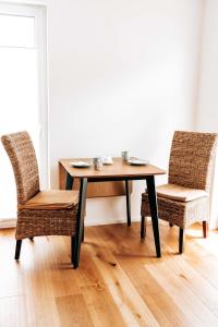 a wooden table with two chairs and a table and chairs at Seetraum Steffi in Zoznegg +17 photos